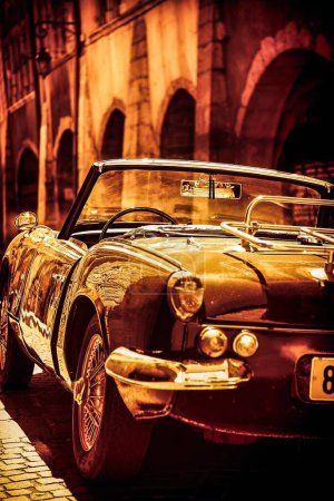 Photo for Annecy, France - Augustus 24, 2008: A classic vintage triump car parked on the sidewalk of a small street in medieval Annecy - Royalty Free Image