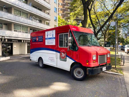 Photo for Toronto, canada - 24 October 2022: a post canada mail truck unloading in front of an apartment building - Royalty Free Image