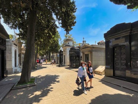 Photo for Buenos aires, argentina - 28 October 2022: people visiting and walking around the world famous landmark the La Recoleta cemetery with historic monumental graves with sculptures an architectural wonder - Royalty Free Image