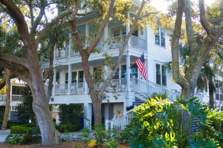 Téléchargez les photos : Charleston, États-Unis - 5 novembre 2022 : ancienne propriété de plage historique avec véranda et étoiles américaines et drapeau à rayures - en image libre de droit