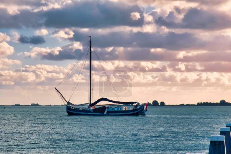Photo for Volendam, netherlands - 08 October 2022: an old historic dutch sail boat is laying on the water of the ijsselmeer - Royalty Free Image