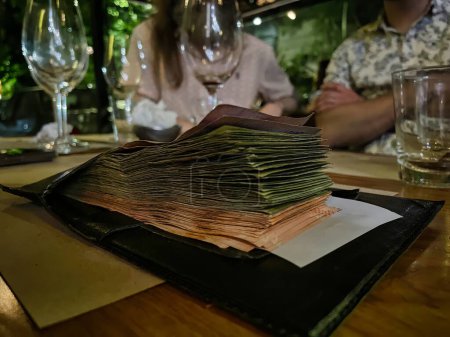 Photo for Buenos aires, argentina - 29 October 2022: paying after a dinner with a devaluation currency in a country with high inflation - Royalty Free Image