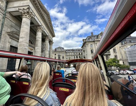 Photo for Copenhagen, denmark - July 24 2023: people are sitting on the upper deck of a sightseeing tour bus driving through the historic city - Royalty Free Image