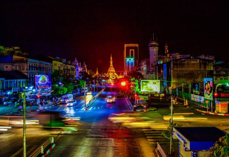 Photo for Yangon, Myanmar - December 02 2012 : the famous Sule Pagoda in Yangon Myanmar at night and the lively street life - Royalty Free Image