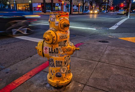 Photo for San Rafael, United States - February 16 2020: a fire hydrant placed at the corner of two streets seen at night - Royalty Free Image