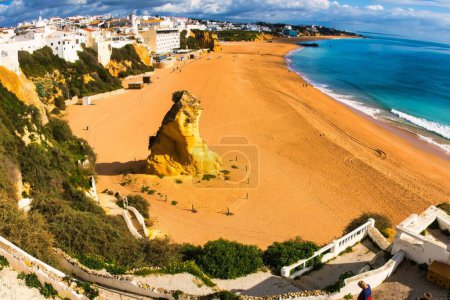 Photo for Albufeira, Portugal - January 18, 2016 : An overview of Albufeira beach. The rock on the beach in the middle of this wide angle picture. - Royalty Free Image
