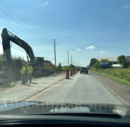 Photo for Cobourg, canada - august 16 2023: construction work is going on on a countryside road with heavy machinery and people working in protective clothing - Royalty Free Image