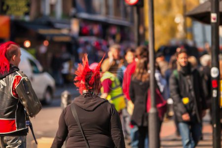 Photo for London, United Kingdom - March18 2009 : hipster grungy looking people pass by on colorful camden road market - Royalty Free Image