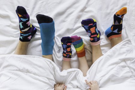 Colorful socks on feet as a symbol of World Down Syndrome Day.	