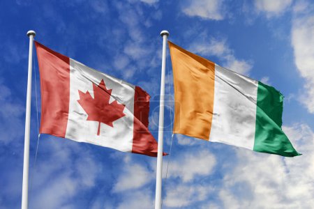 Ilustración 3d. Bandera de Canadá y Costa de Marfil ondeando en el cielo. Alta bandera ondeante detallada. Representación 3D. Saludando en el cielo. Banderas ondeaban en el cielo nublado.