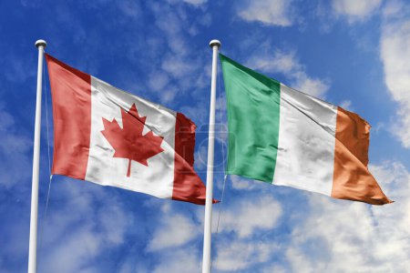 3D-Illustration. Kanadas und Irlands Flagge weht am Himmel. Hoch detaillierte Fahnenschwenken. 3D-Renderer. Winken im Himmel. Fahnen flatterten in den bewölkten Himmel.
