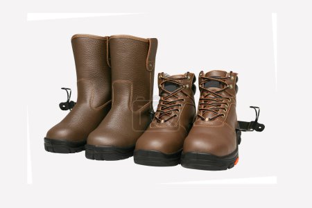 Foto de Photo of brown leather shoes with a white background, these shoes are usually worn by mountain climbers, workers, motorbikers and hikers - Imagen libre de derechos