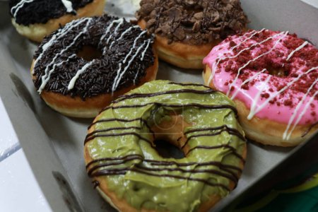 Foto de Donuts with various flavors, chocolate, cheese, teramisu, strawberries, nuts and avocado - Imagen libre de derechos