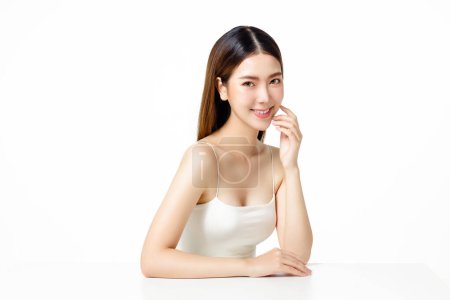 Photo for Asian woman with a beautiful face and fresh, smooth skin. Cute female model with natural makeup and sparkling eyes is posing and looking at the camera on white isolated background. - Royalty Free Image