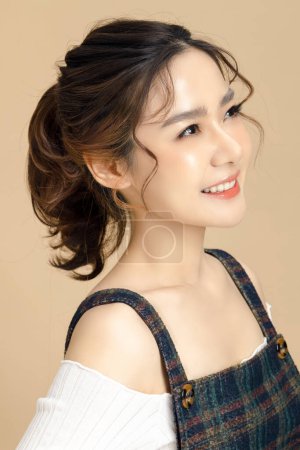 Photo for Beautiful asian woman model with natural makeup and clean fresh skin on yellow background. Face care, Facial treatment, Cosmetology, beauty and spa, Women portrait. - Royalty Free Image