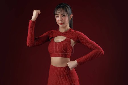 Photo for Energetic Asian fit slim good shape body building athletic woman in red sportwear workout indoor studio. Young strong female model aerobic training skin care, wellness, Health insurance. - Royalty Free Image