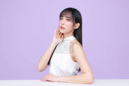 Photo for Beautiful young Asian woman model long hair with natural makeup on face clean skin on isolated violet background. Cute girl portrait, Facial treatment, Body care, Beauty and Spa. - Royalty Free Image