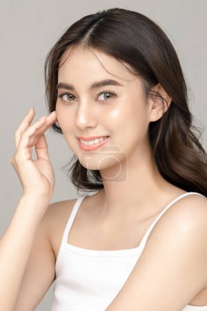 Photo for Beautiful young Asian woman model with perfect clean fresh skin on grey background. Face care, Facial treatment, Cosmetology, Plastic Surgery, Lovely girl portrait in studio. - Royalty Free Image