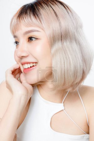 Photo for Asian woman with a beautiful face and Perfect clean fresh skin. Portrait of female model with natural makeup and sparkling eyes on white isolated background. Cosmetology, Body care, plastic surgery. - Royalty Free Image
