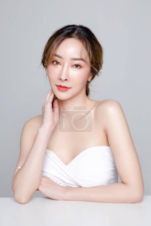 Photo for Asian woman with a beautiful face and Perfect clean fresh skin. Portrait of female model with natural makeup on Grey background. Cosmetology, Body care, plastic surgery, Facial treatment, Beauty. - Royalty Free Image