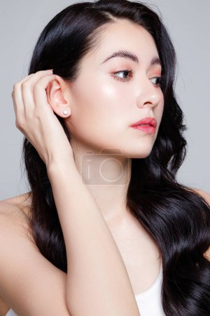 Photo for Close up of young woman with a beautiful face and Perfect clean fresh skin. Portrait of female model with natural makeup and sparkling eyes on Grey isolated background. Cosmetology, plastic surgery. - Royalty Free Image