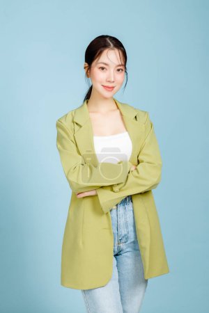 Photo for Young happy smiling successful employee business woman 20s in casual green fashion jacket crossed arms isolated on pastel blue background. Female entrepreneurs or office worker concept. - Royalty Free Image