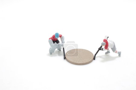 Photo for An Ice Hokey Player push the coins - Royalty Free Image