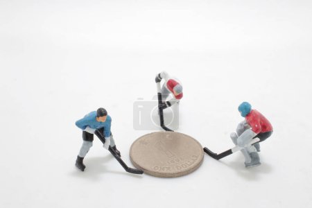 Photo for An Ice Hokey Player push the coins - Royalty Free Image