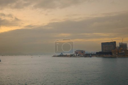 Photo for Hong Kong - Dec 08, 2023: Scenic view of modern cityscape under cloudy sky at sunset time - Royalty Free Image