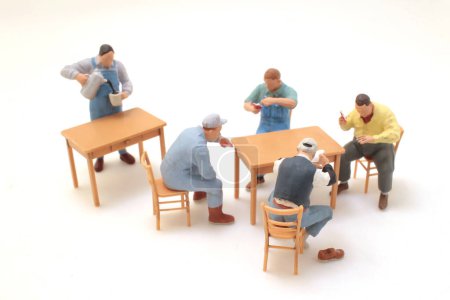Téléchargez les photos : The Group of People Sitting and Standing Around a Table - en image libre de droit