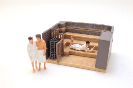 Téléchargez les photos : A scale of model sauna with figure - en image libre de droit