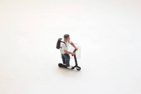 Foto de A figure Person riding an electric scooter, - Imagen libre de derechos