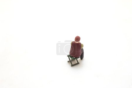 Photo for Figurine of a solitary person sitting on bench alone - Royalty Free Image