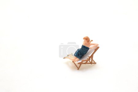 Photo for A Tiny figurine of a woman in elegant dress on white. - Royalty Free Image
