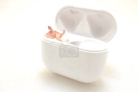 Photo for Miniature Person Relaxing in an Open White Container - Royalty Free Image