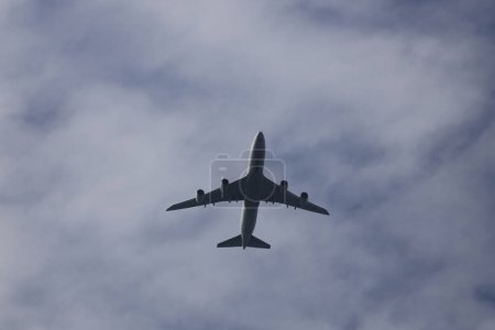 Photo for Jan 13 2024 Passenger airplane flying above clouds at hong kong - Royalty Free Image