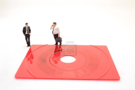 Photo for A Business figurine standing on a compact disk - Royalty Free Image