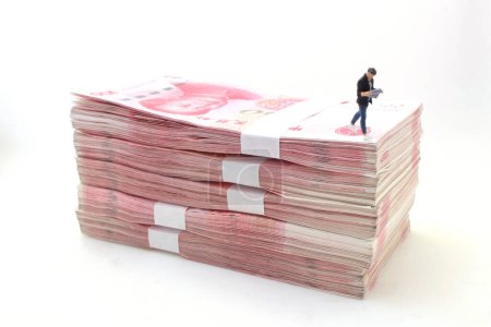 Photo for A figure man walk on the Stacks of Chinese Yuan Banknotes - Royalty Free Image