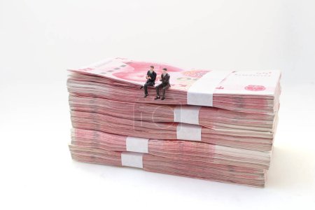 Photo for Business man sit on Stacks of Chinese Yuan Banknotes - Royalty Free Image