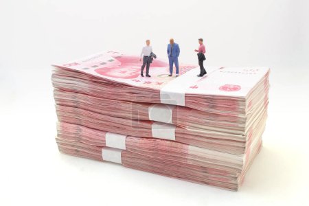 Photo for Business men stand on Stacks of Chinese Yuan Banknotes, - Royalty Free Image