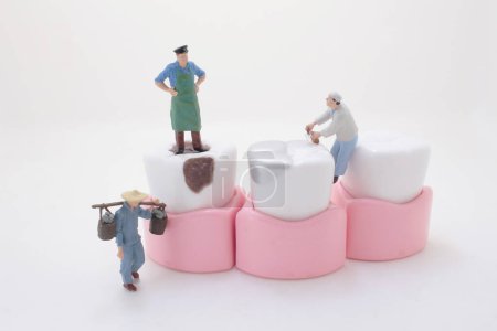 Photo for Miniature creative worker cleaning teeth, the fun of figure - Royalty Free Image