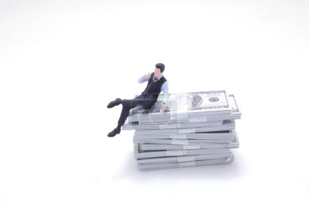 Photo for A fun of figure Man from stack of dollars - Royalty Free Image