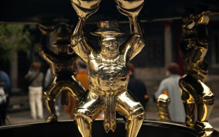 Golden statue in a display at the landmark Longshan Buddhist Temple in Taipei