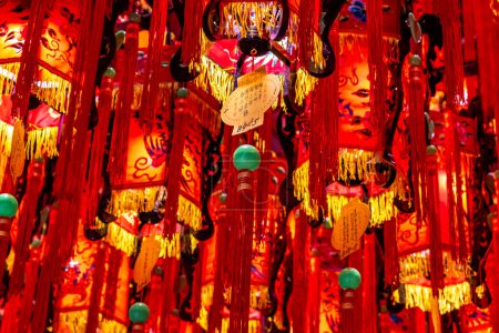 Colorful red and yellow lanterns hanging from the ceiling of the landmark Tianhou Buddhist Temple in the Ximen district of Taipei