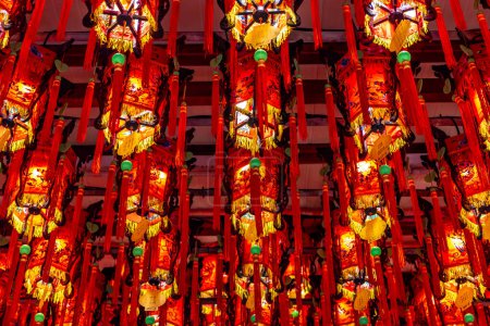 Colorful red and yellow lanterns hanging from the ceiling of the landmark Tianhou Buddhist Temple in the Ximen district of Taipei