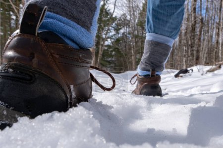 Photo for Close up of winter hiker walking along a winter trail. - Royalty Free Image