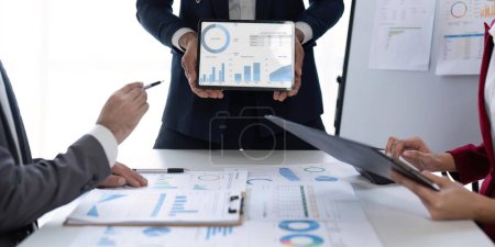 Photo for Businessmen team or financial data analysts working with tablets data graphs together. Plan to analyzing projects in the office. - Royalty Free Image