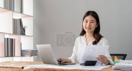 Photo for Business woman analyst sales management, taxes financial data documents or marketing report papers working in office using laptop.. - Royalty Free Image