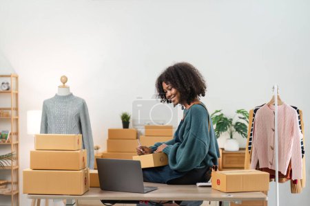 Photo for Young attractive woman owner startup business work happy with box at home prepare parcel delivery in sme supply chain, online delivery idea concept. - Royalty Free Image