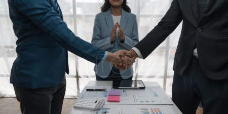 Photo for Business people shaking hands finishing up meeting or negotiation in office. Business handshake and partnership concepts. - Royalty Free Image